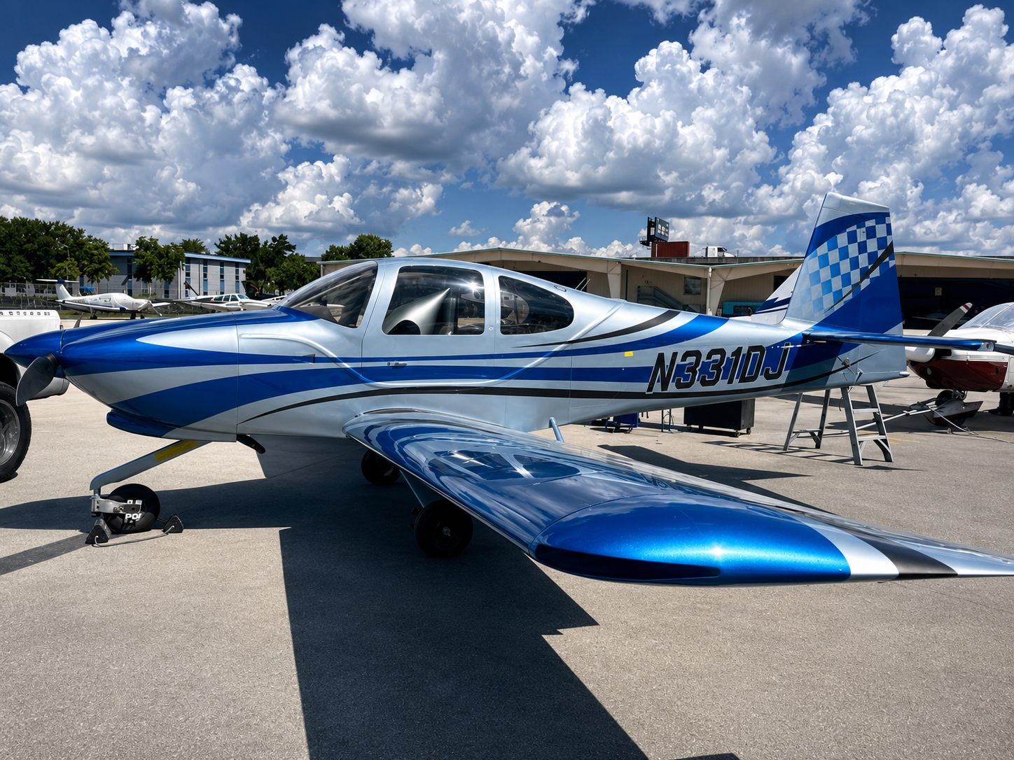 Finished aircraft with a glossy blue, silver, and black checkered livery, polished and ready for final delivery